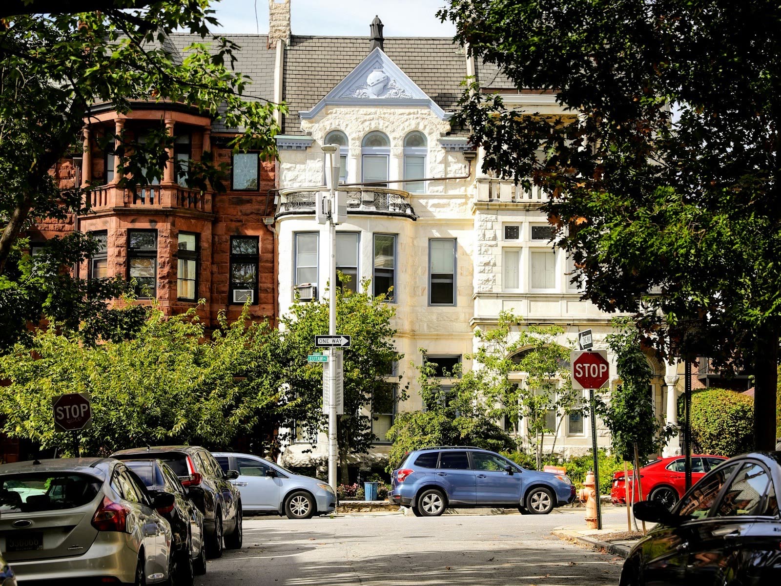 Historic Baltimore brick rowhomes on a tree-lined street